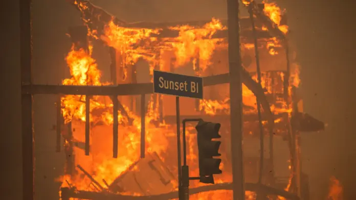 Flames from the Palisades Fire burn a building on Sunset Boulevard amid a powerful windstorm on January 8, 2025 in the Pacific Palisades neighborhood of Los Angeles, California. APU GOMES/GETTY IMAGES (The Hollywood reporter)