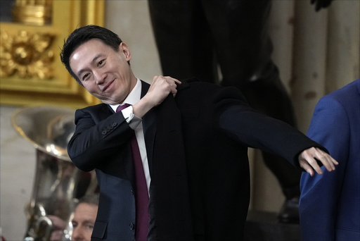 TikTok CEO Shou Chew puts on his coat after the 60th Presidential Inauguration in the Rotunda of the U.S. Capitol in Washington, Monday, Jan. 20, 2025. (AP Photo/Julia Demaree Nikhinson, Pool)