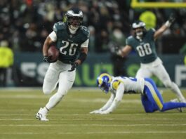 Philadelphia Eagles running back Saquon Barkley (26) runs for a touchdown during the first half of an NFL football NFC divisional playoff game against the Los Angeles Rams on Sunday, Jan. 19, 2025, in Philadelphia. (AP Photo/Matt Slocum)