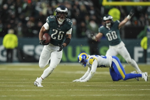 Barkley scores 78 and 62-yard touchdowns in snowy conditions as Eagles defeat Rams 28-22 to advance to NFC Championship game.