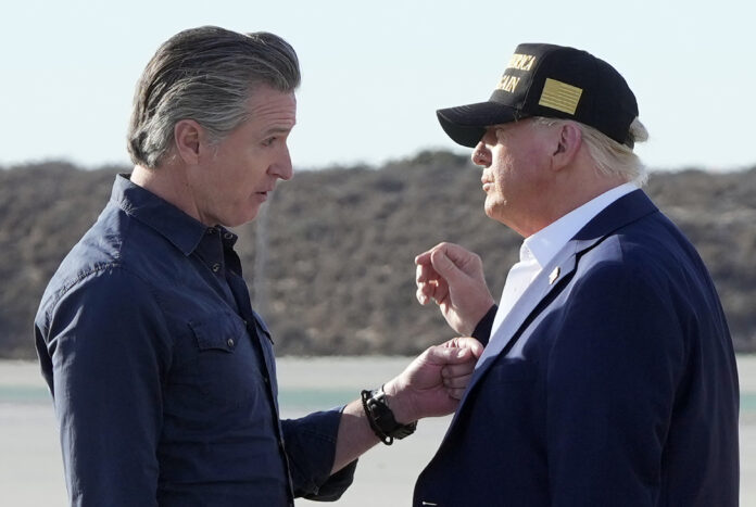 President Donald Trump talks with California Gov. Gavin Newsom after arriving on Air Force One at Los Angeles International Airport in Los Angeles, Friday, Jan. 24, 2025. (AP Photo/Mark Schiefelbein)