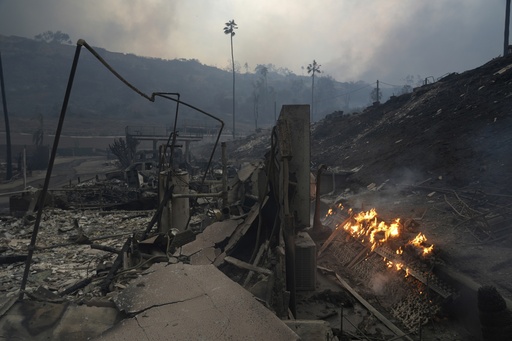 The Palisades Fire ravages a neighborhood amid high winds in the Pacific Palisades neighborhood of Los Angeles, Tuesday, Jan. 7, 2025. (