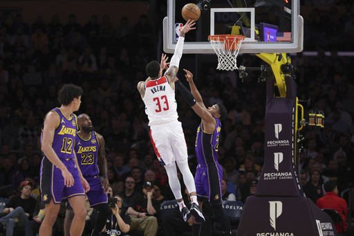 LeBron records a triple-double just a day after supporting the Buckeyes in Atlanta, as the Lakers defeat the Wizards 111-88.