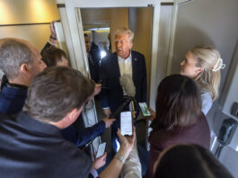 President Donald Trump speaks to reporters aboard Air Force One as he travels from Las Vegas to Miami on Saturday, Jan. 25, 2025. (AP Photo/Mark Schiefelbein)