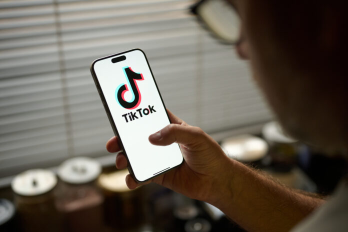 The TikTok app logo is seen in this photo illustration taken in Warsaw, Poland on 18 November, 2024. The Canadian government has ordered the social media giant to wind down its business operations in the country. The decision, announced on Nov. 7, is based on national security concerns tied to TikTok's Chinese ownership and follows a year-long review of the app's Canadian operations. (Photo by Jaap Arriens/NurPhoto via Getty Images)