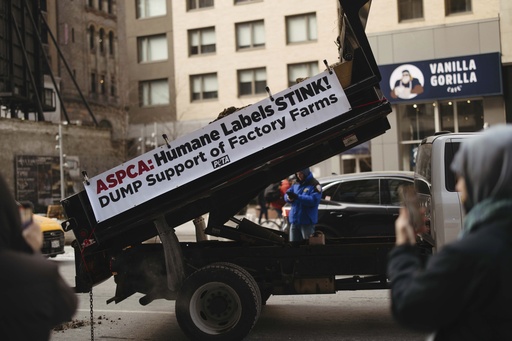 PETA demonstrators detained for attempting to throw frozen feces outside competitor’s headquarters.