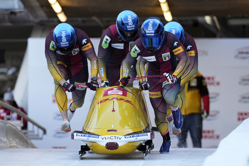 Friedrich of Germany secures bobsled gold, marking his 100th victory at World Cup and championship events.