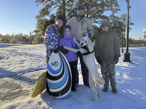 Gulf Coast enjoys a unique snow day with boogie board sledding and ice hockey on Canal Street