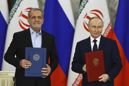 Russian President Vladimir Putin, right, and Iranian President Masoud Pezeshkian attend a signing ceremony at the Kremlin in Moscow, Russia, Friday, Jan. 17, 2025. (Evgenia Novozhenina/Pool Photo via AP)