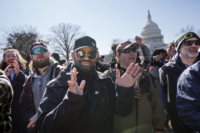 Former Proud Boys leader Enrique Tarrio, is flanked by Dominic Pezzola, left, and Joseph Biggs, right, at a news conference outside the U.S. Capitol in Washington, Friday, Feb. 21, 2025. (AP Photo/J. Scott Applewhite)