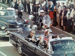 US President John F Kennedy, First Lady Jacqueline Kennedy, Texas Governor John Connally, and others smile at the crowds lining their motorcade route in Dallas, Texas, on November 22, 1963. Minutes later the President was assassinated as his car passed through Dealey Plaza.