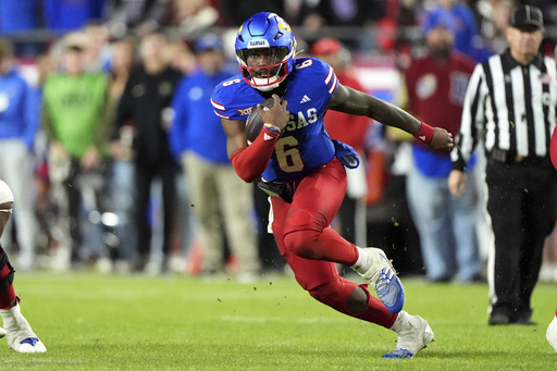 Kansas quarterback Jalon Daniels undergoes minor knee procedure, affecting spring training participation.