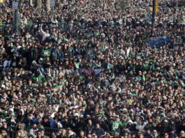 Fans look on during the national anthem during the Philadelphia Eagles NFL football Super Bowl 59 parade and celebration, Friday, Feb. 14, 2025, in Philadelphia. (AP Photo/Matt Rourke)