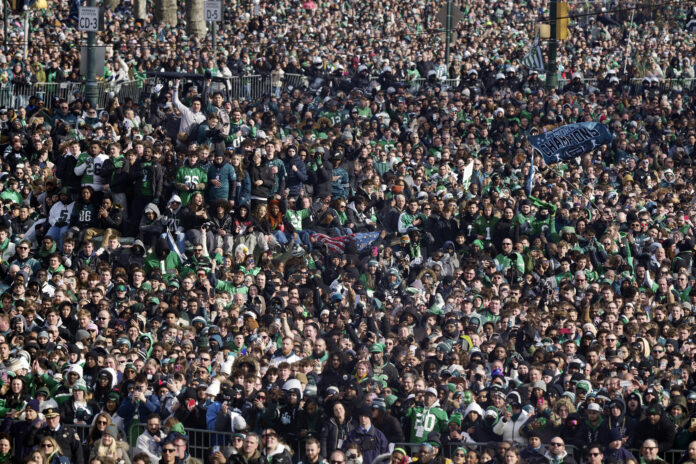 Fans look on during the national anthem during the Philadelphia Eagles NFL football Super Bowl 59 parade and celebration, Friday, Feb. 14, 2025, in Philadelphia. (AP Photo/Matt Rourke)