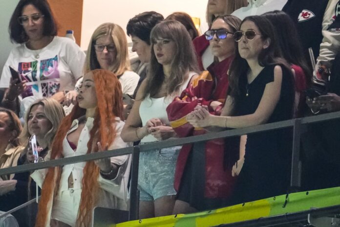 Ice Spice, from left, Taylor Swift, Este Haim and Alana Haim watch during the first half of the NFL Super Bowl 59 football game between the Kansas City Chiefs and the Philadelphia Eagles, Sunday, Feb. 9, 2025, in New Orleans. (AP Photo/Gerald Herbert)