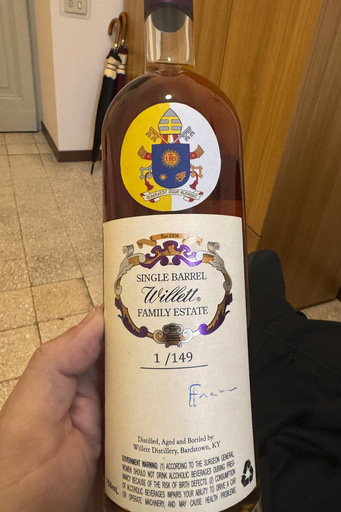 Charity auction of bourbon bottles autographed by the pope nets substantial funds in Kentucky