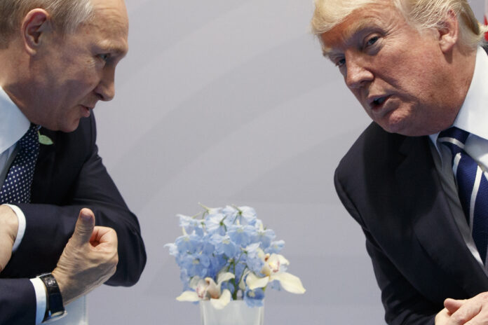 Then-U.S. President Donald Trump, right, meets with Russian President Vladimir Putin at the G20 Summit in Hamburg, Germany, Friday, July 7, 2017. (AP Photo/Evan Vucci, File)