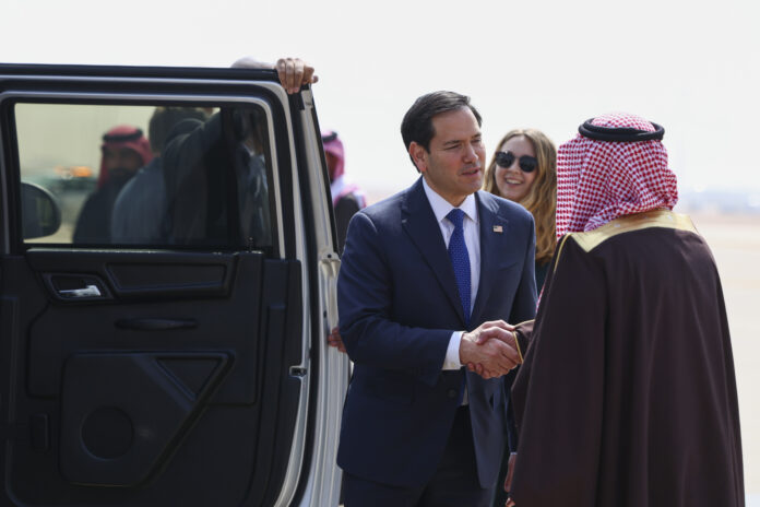 U.S. Secretary of State Marco Rubio shakes hands with Saudi Arabia's Deputy Minister for Protocol Affairs Abdulmajeed Al-Smari, right, as he arrives at King Khalid International Airport in Riyadh, Saudi Arabia, Monday Feb. 17, 2025. (Evelyn Hockstein/Pool Photo via AP)