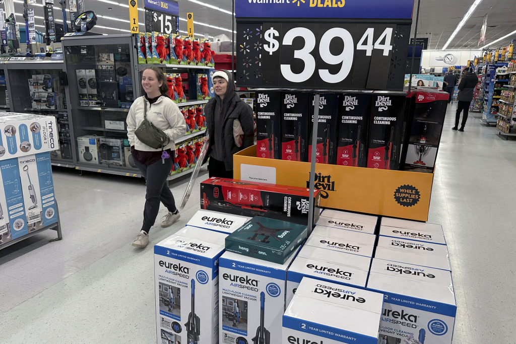 FILE - People shop for Black Friday deals at a Walmart store in Rochester, New York on Friday, November 29, 2024. (AP Photo/Ted Shaffrey, File)