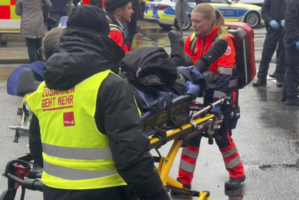 An injured person is taken away by emergency services at the scene of an accident after a driver hit a group of people in Munich, Germany, Thursday Feb. 13, 2025. (Michael Fischer/dpa via AP)