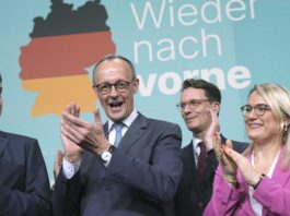 Friedrich Merz, second left, leader of the Christian Democratic Union (CDU), applauds while addressing supporters at the party headquarters in Berlin, Germany, Sunday, Feb. 23, 2025, after the German national election. (Michael Kappeler/dpa via AP)