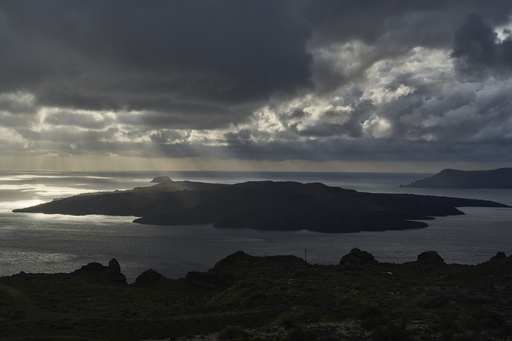 Amidst numerous earthquakes shaking Greek islands, a handful of adventurous tourists find Santorini relatively empty.