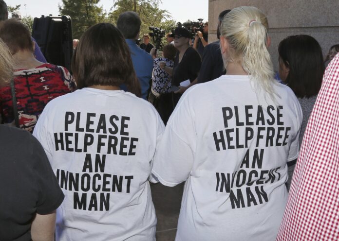 Ericka Glossip-Hodge, left, daughter of Richard Glossip, and Billie Jo Ogden Boyiddle, right, Richard Glossip's sister, listen during a rally to stop the execution of Richard Glossip, in Oklahoma City, Tuesday, Sept. 15, 2015. (AP Photo/Sue Ogrocki, File)