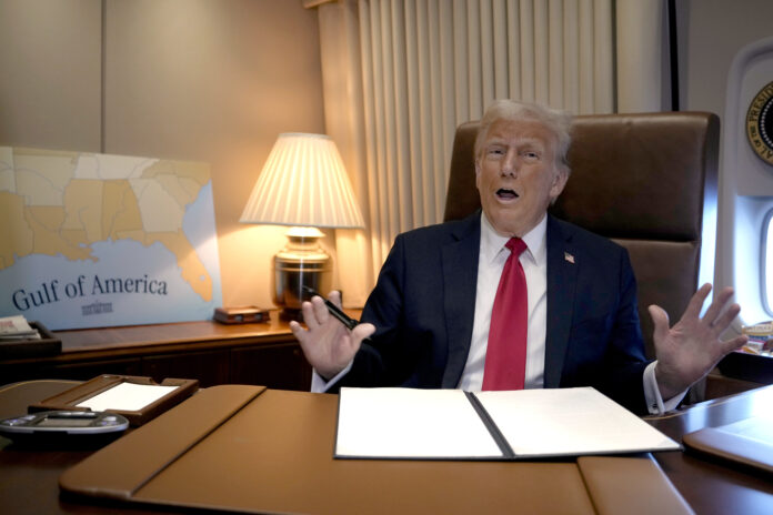 President Donald Trump speaks to reporters aboard Air Force One as he prepares to sign a proclamation declaring Feb. 9 Gulf of America Day as he travels from West Palm Beach, Fla. to New Orleans, Sunday, Feb. 9, 2025. (AP Photo/Ben Curtis)