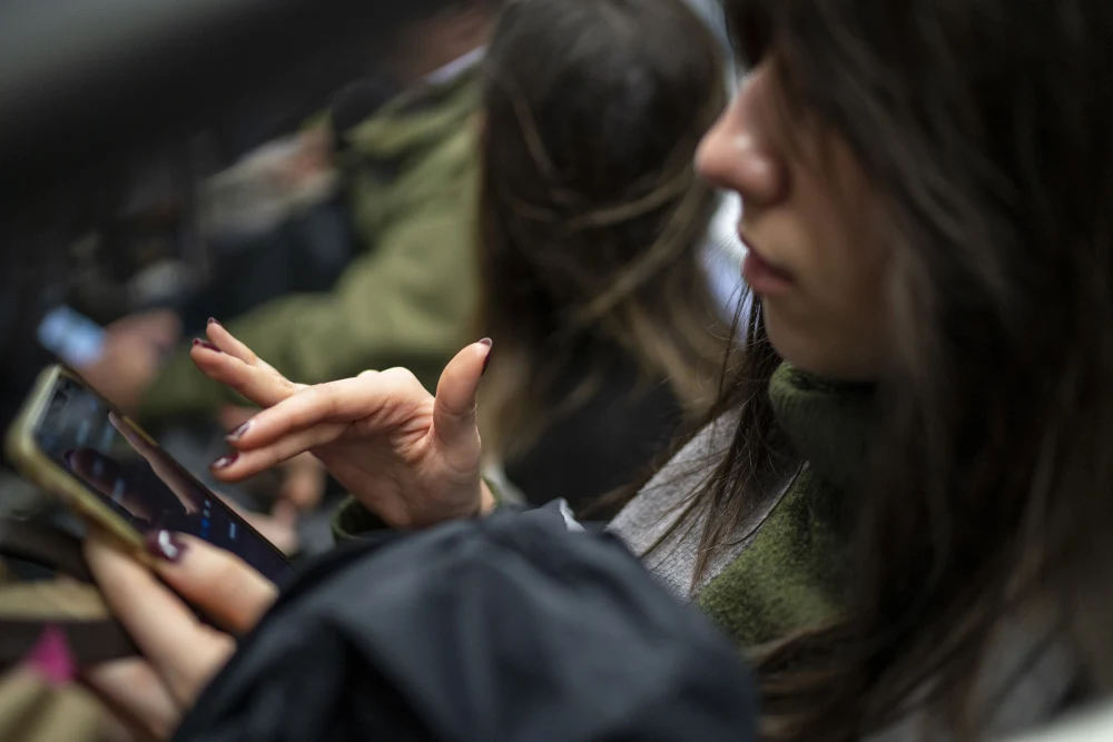 A subway passenger uses an iPhone in New York City last March. Robert Nickelsberg / Getty Images file