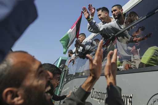 Freed Palestinian prisoners are greeted by a crowd as they arrive in the Gaza Strip after being released from an Israeli prison following a ceasefire agreement between Hamas and Israel in Khan Younis, Saturday, Feb. 1, 2025. (AP Photo/Jehad Alshrafi)