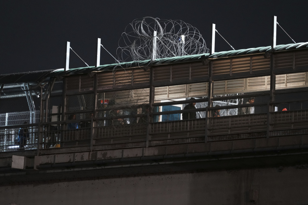 Pedestrians cross the International bridge, Thursday, Feb. 13, 2025, in Hidalgo, Texas. (AP Photo/Eric Gay)