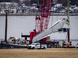 Salvage crews work near the wreckage site in the Potomac River of a mid-air collision between an American Airlines jet and a Black Hawk helicopter, at Ronald Reagan Washington National Airport, Wednesday, Feb. 5, 2025, in Arlington, Va. (AP Photo/Ben Curtis)