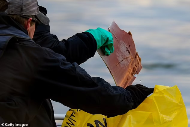 A forensic team collects a piece of debris from the Potomac River

