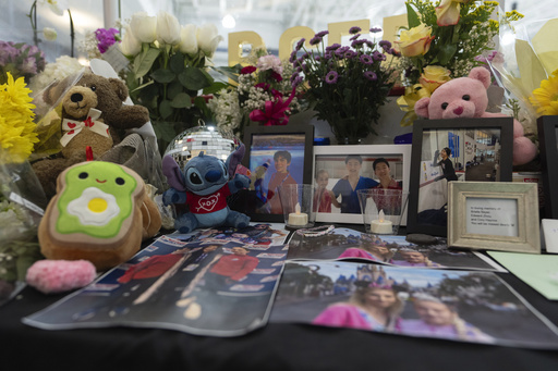 A memorial is seen along the boards at MedStar Capitals Iceplex Sunday, Feb. 2, 2025, in Arlington, Va., for the figure skaters who were among the 67 victims of a mid-air collision between an Army helicopter and an American Airlines flight from Kansas. (AP Photo/Carolyn Kaster)