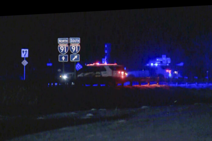 FILE - This image taken from video provided by WCAX shows police cars closing off a road after a shooting involving a U.S. Border Patrol agent on Interstate 91 near Coventry, Vt., on Jan. 20, 2025. (WCAX via AP, File)