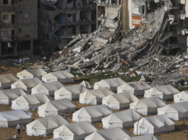 A tent camp for displaced Palestinians is set up next to destroyed buildings following the Israeli air and ground offensive in Jabaliya, Gaza Strip, Thursday, Feb. 6, 2025. (AP Photo/Abdel Kareem Hana)