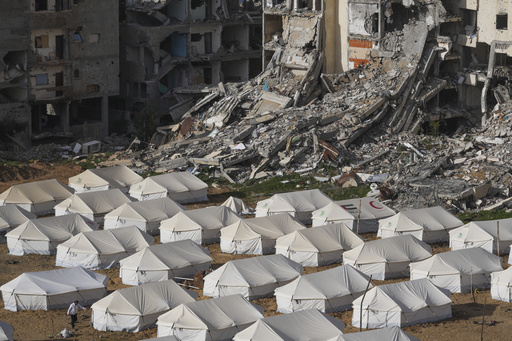 A tent camp for displaced Palestinians is set up next to destroyed buildings following the Israeli air and ground offensive in Jabaliya, Gaza Strip, Thursday, Feb. 6, 2025. (AP Photo/Abdel Kareem Hana)