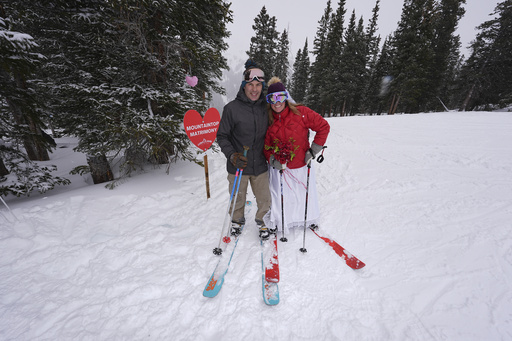 Numerous pairs tie the knot at a snowy ski resort in Colorado on Valentine’s Day.