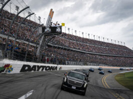 President Donald Trump rides in the presidential limousine known as "The Beast" as he takes a pace lap ahead of the start of the NASCAR Daytona 500 auto race at Daytona International Speedway, Sunday, Feb. 16, 2025, in Daytona Beach, Fla. (AP Photo/Chris O'Meara)