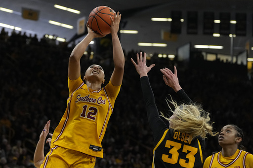 Iowa shocks No. 4 USC, snapping the Trojans’ 15-game winning run, while Clark has her jersey honored.