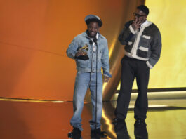 Kendrick Lamar, left, accepts the record of the year award