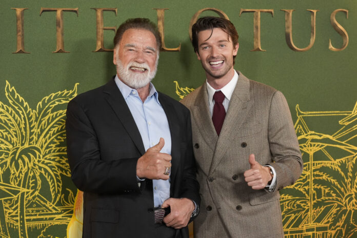 Arnold Schwarzenegger, left, and Patrick Schwarzenegger give the thumbs up at the season three premiere of 