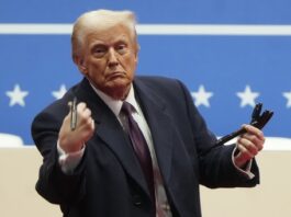 FILE - President Donald Trump throws pens used to sign executive orders to the crowd during an indoor Presidential Inauguration parade event in Washington, Monday, Jan. 20, 2025. (AP Photo/Matt Rourke, File)