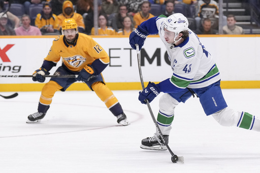 Quinn Hughes, standout defenseman for the Canucks, misses game against Red Wings due to an undisclosed injury.