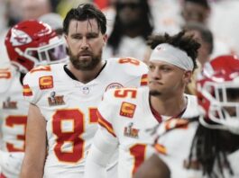 Kansas City Chiefs tight end Travis Kelce (87) quarterback Patrick Mahomes (15) and running back Kareem Hunt (29) walk off the field at the halftime break during the NFL Super Bowl 59 football game against the Philadelphia Eagles, Sunday, Fe