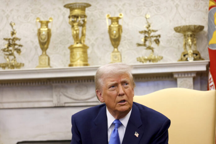 President Donald Trump speaks during a meeting with France's President Emmanuel Macron in the Oval Office of the White House in Washington, Monday, Feb. 24, 2025. (Ludovic Marin/Pool via AP)