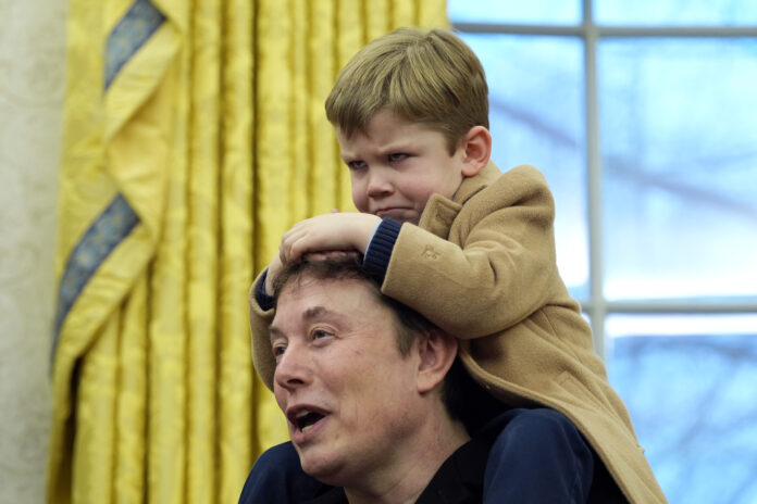 Elon Musk, joined by his son X Æ A-Xii, speaks during an event with President Donald Trump in the Oval Office at the White House, Tuesday, Feb. 11, 2025, in Washington. (Photo/Alex Brandon)