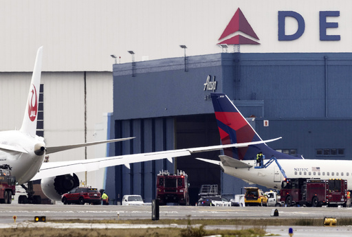 Japan Airlines aircraft taxis and reportedly brushes against parked Delta plane at Seattle airport.