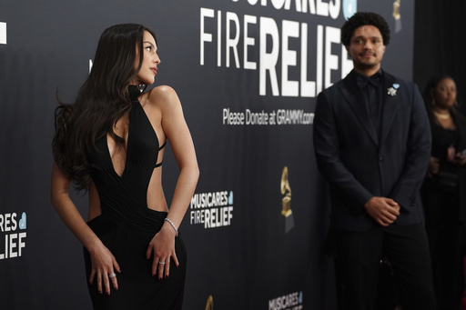 Olivia Rodrigo, left, and Trevor Noah arrive at the 67th annual Grammy Awards