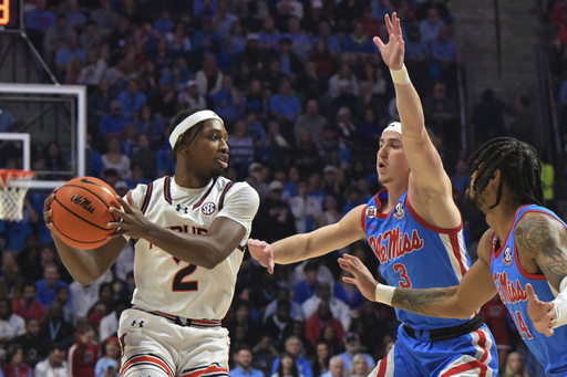 Johni Broome’s 20 points and 12 rebounds aid No. 1 Auburn in defeating No. 23 Ole Miss 92-82.